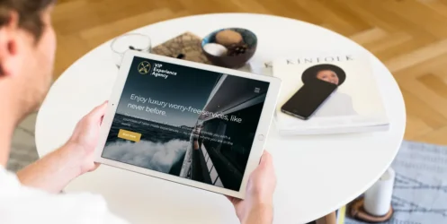 mockuuups-sitting-on-couch-and-holding-ipad-pro-mockup